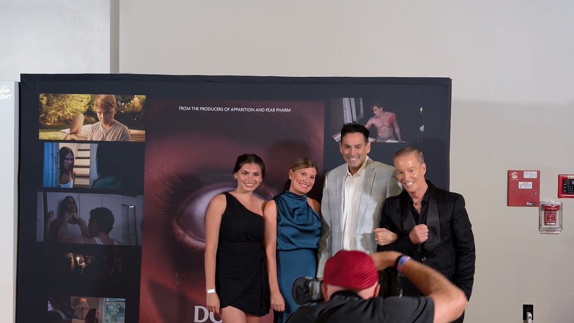 Howard Burd with cast and family at a film premiere step-and-repeat