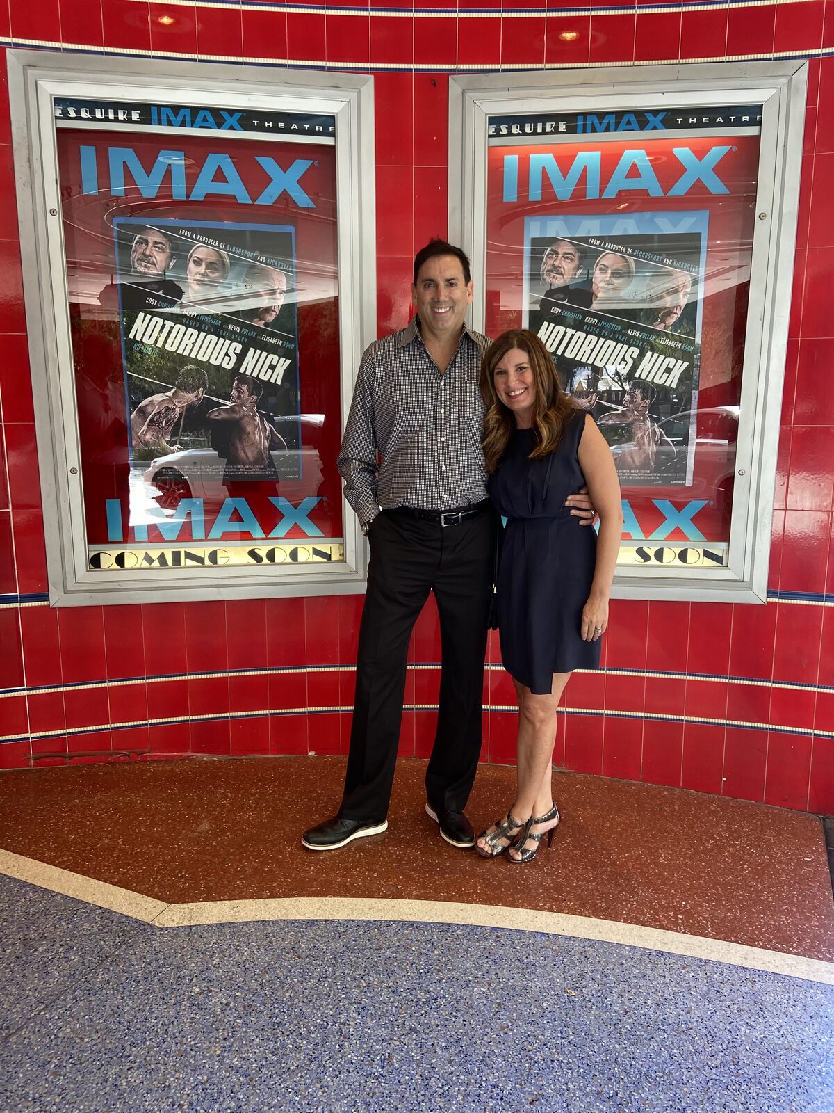 Howard Burd beside Notorious Nick posters at the IMAX theatre